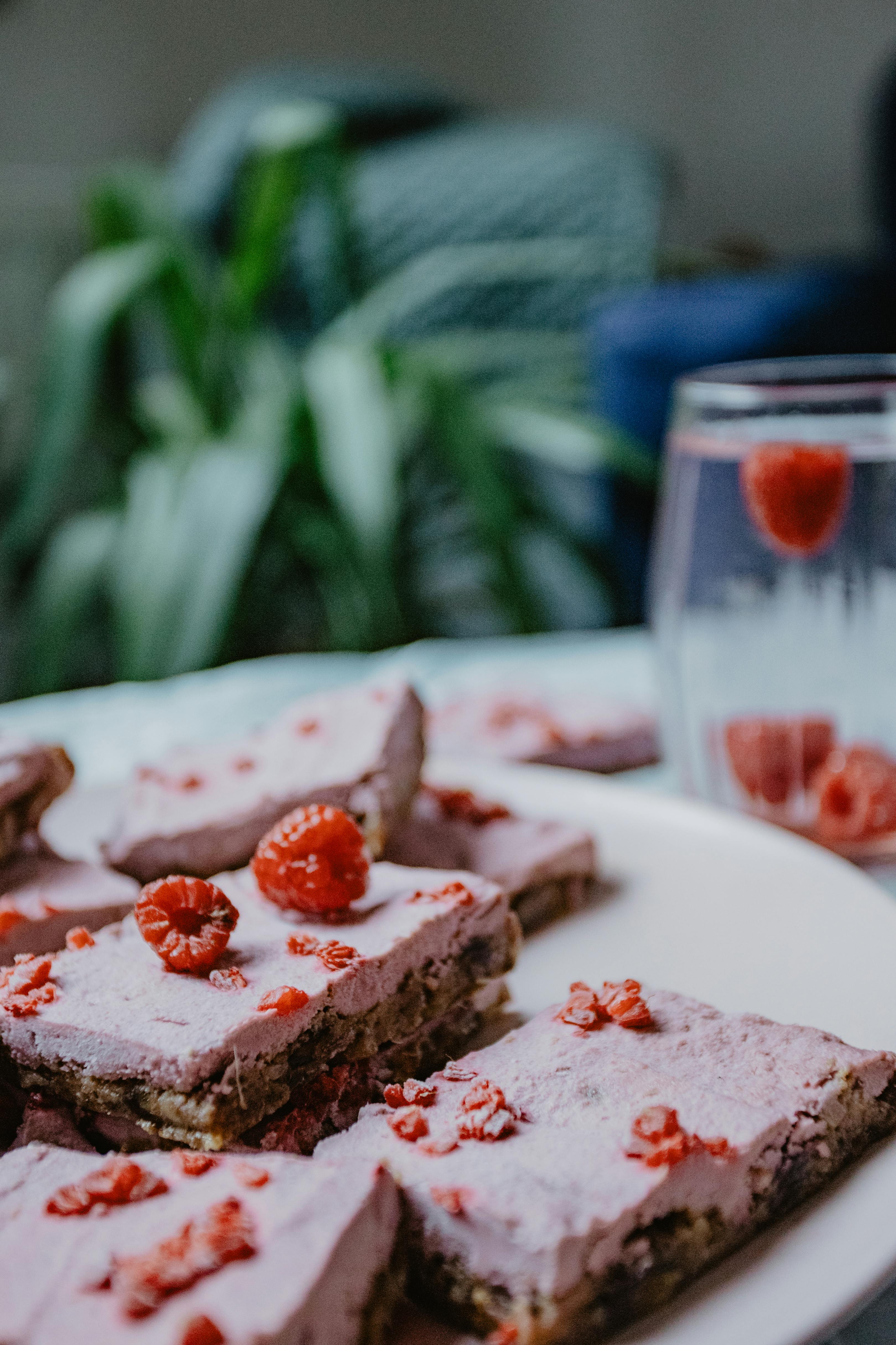 sliced cake with raspberry on top