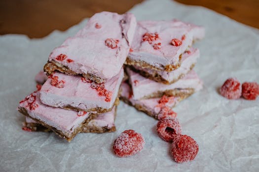 A mouthwatering stack of raspberry dessert bars with a crust, perfect for sweet lovers.