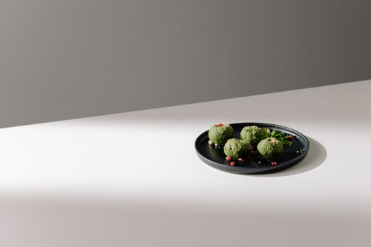 Spinach Pkhali on Black Plate