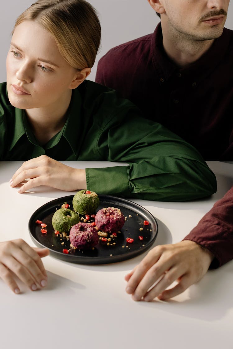 Couple Sitting With Food On Their Table