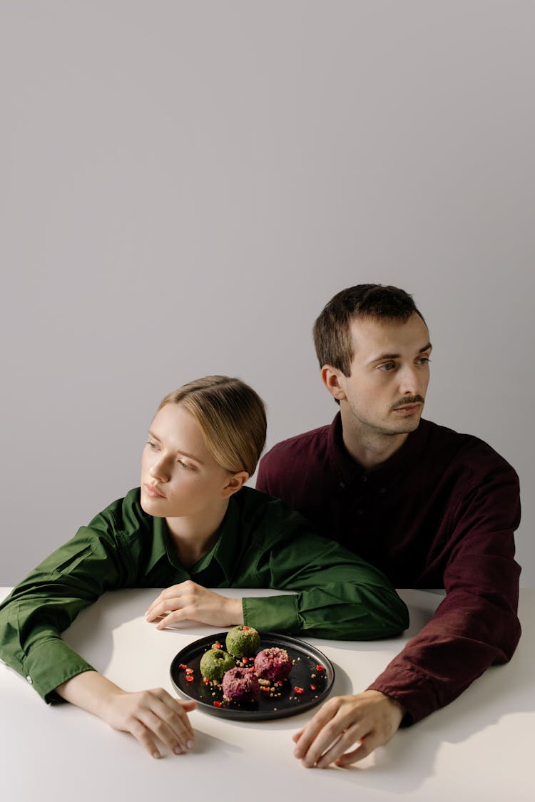 Couple Sitting With Food On Their Table