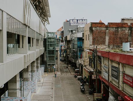 View of a commercial street near an MRT station in Jakarta, showcasing urban architecture and infrastructure.