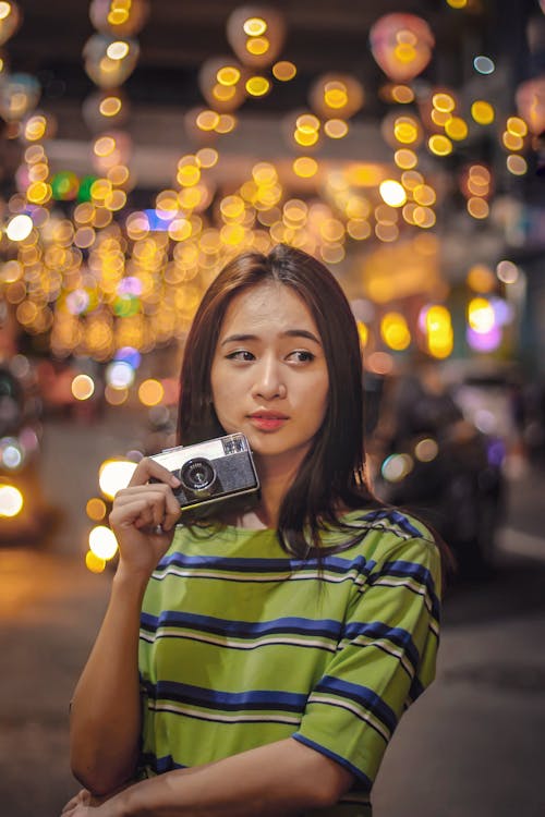 Young Asian woman with vintage photo camera