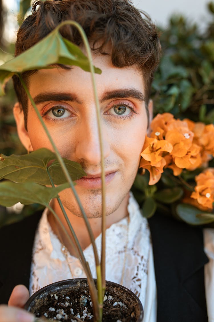 Portrait Of A Person Holding A Plant