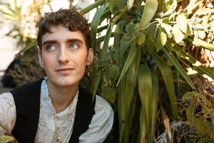 A Man Posing With Plant 