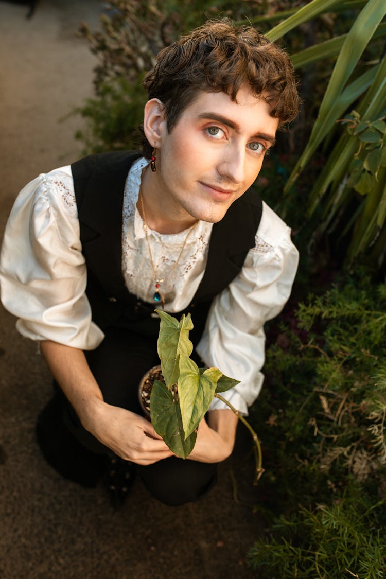 Man Holding A Potted Plant