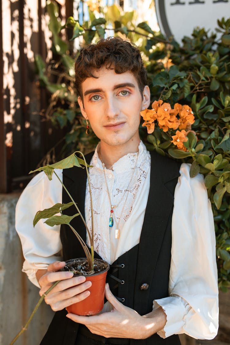 A Person Holding A Potted Plant