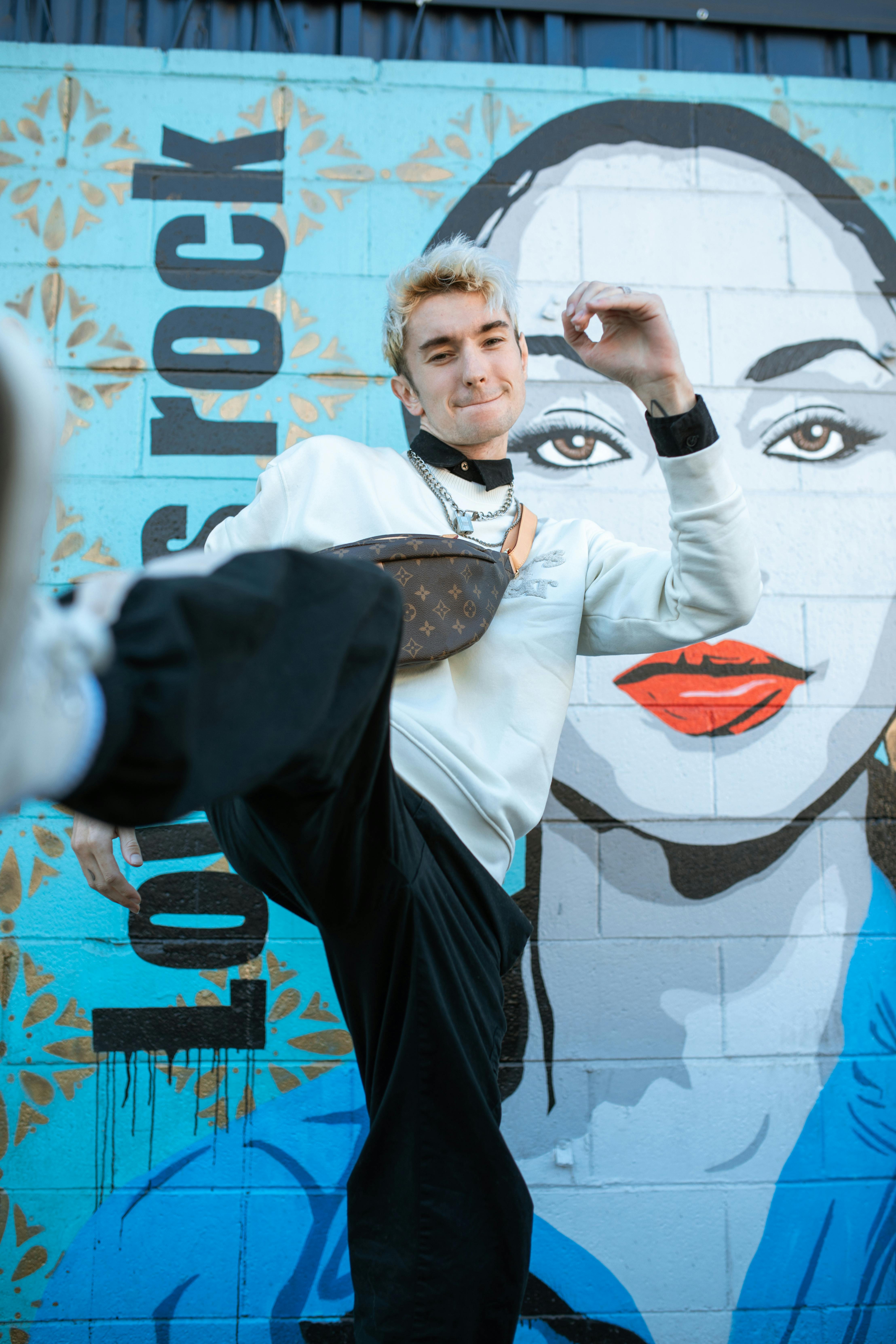 Man in White Long Sleeves Kicking His Foot · Free Stock Photo