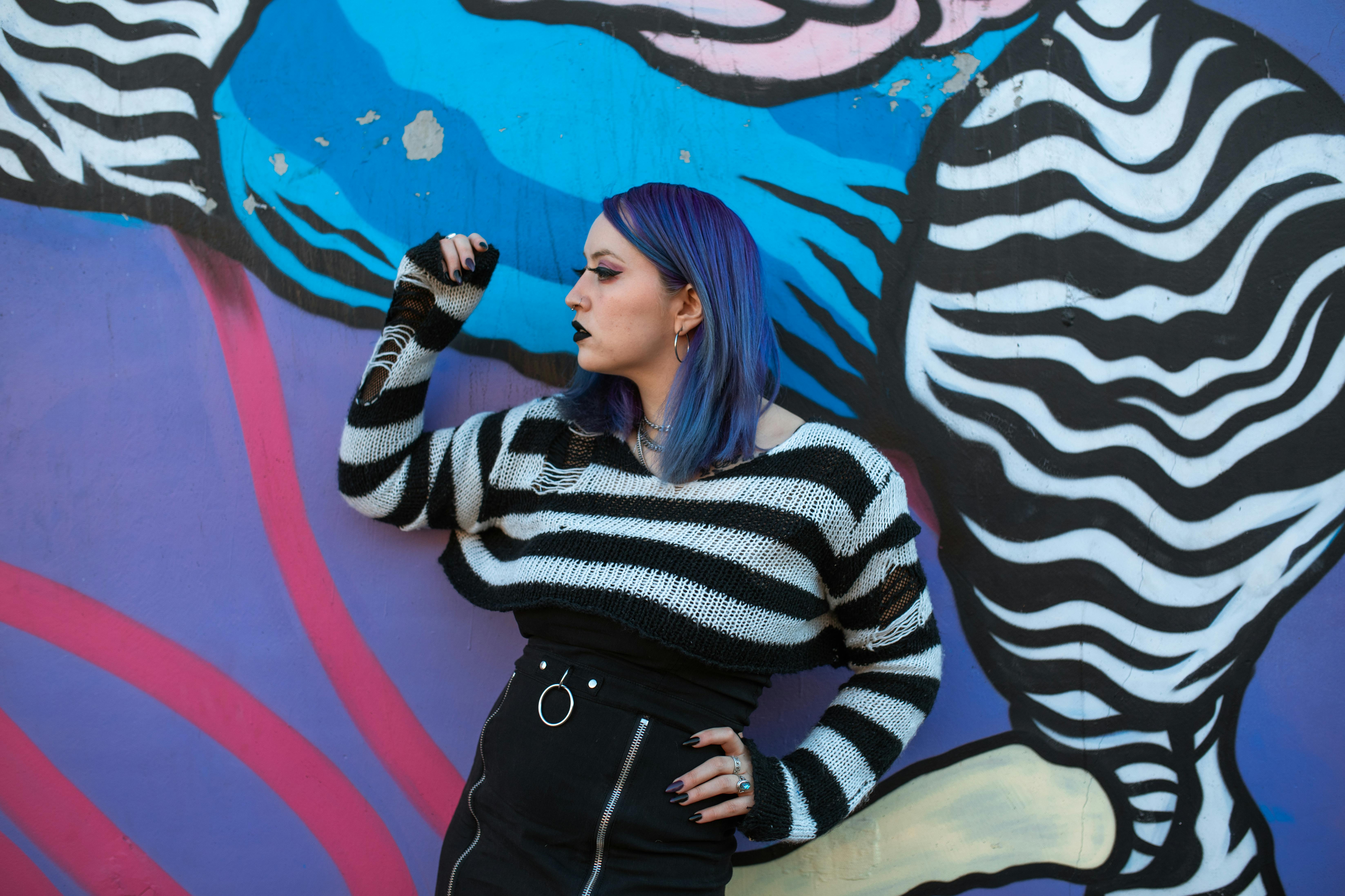 woman in black and white striped long sleeve shirt and black pants