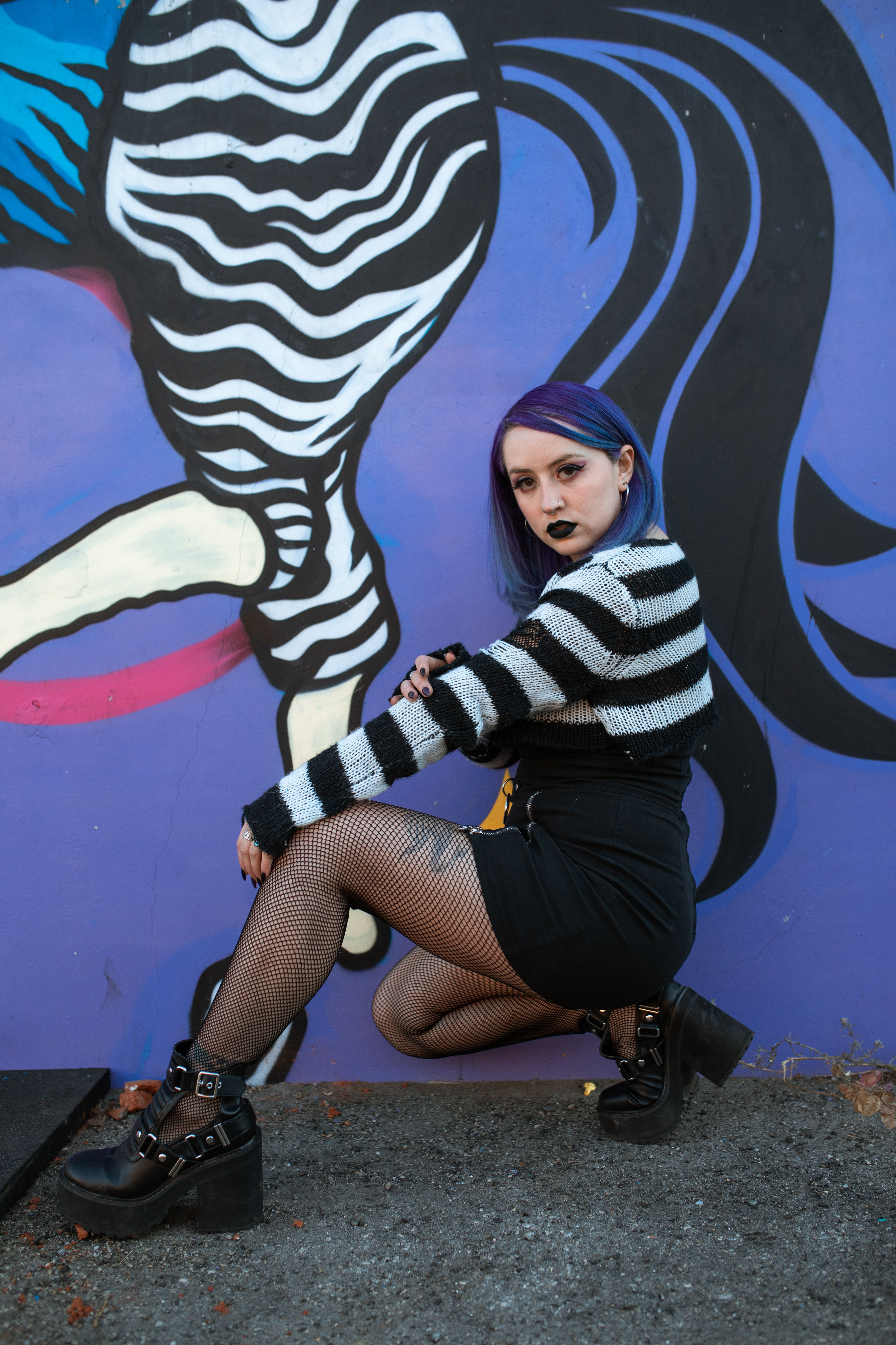 Woman in Black and White Striped Long Sleeve Shirt Sitting on Concrete ...