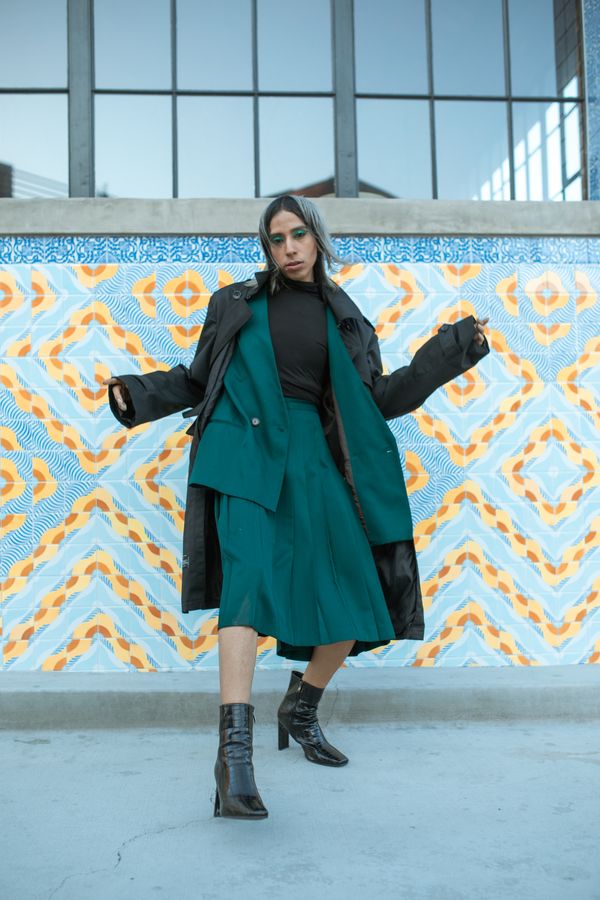 Woman in a pleated midi skirt with a turtleneck