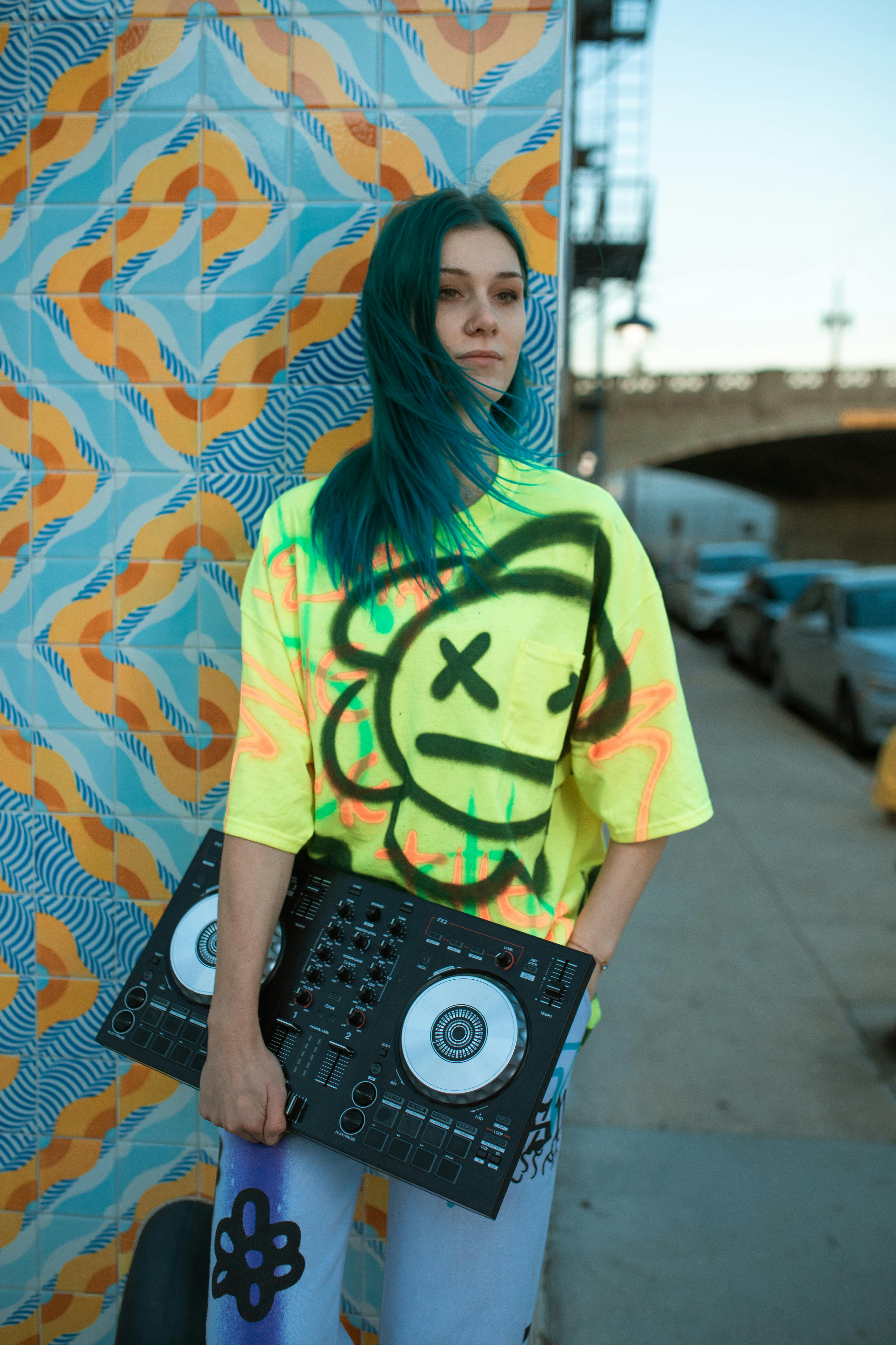 woman in yellow and black t shirt holding black and gray radio