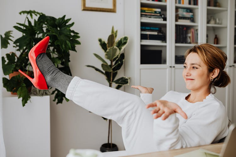 Woman In Tracksuit Sitting On Chair