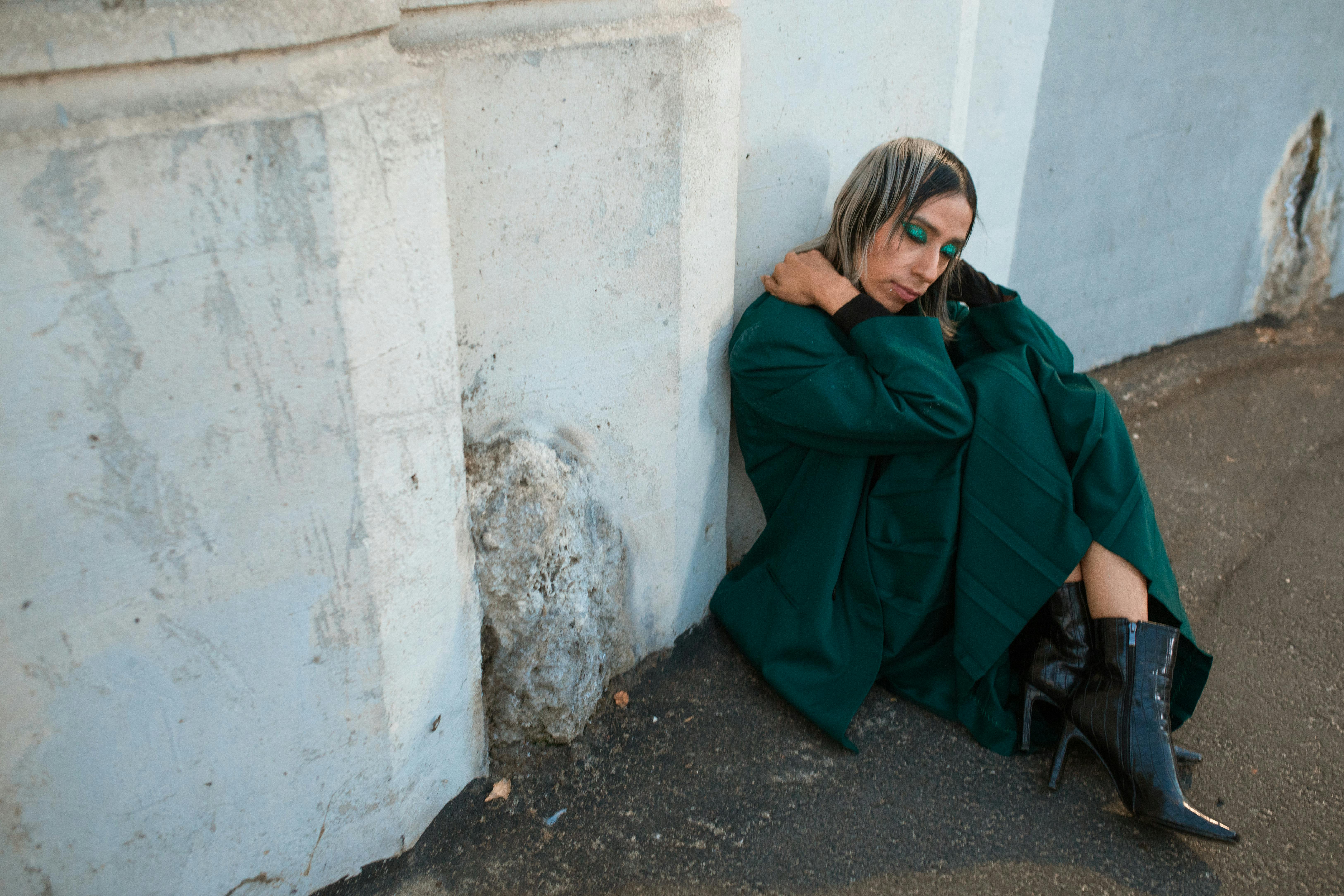 woman in green robe sitting on chair