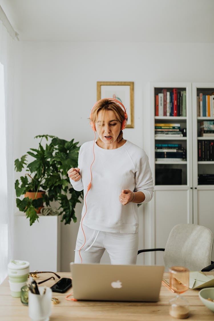 Woman Working Out In Headphones At Home