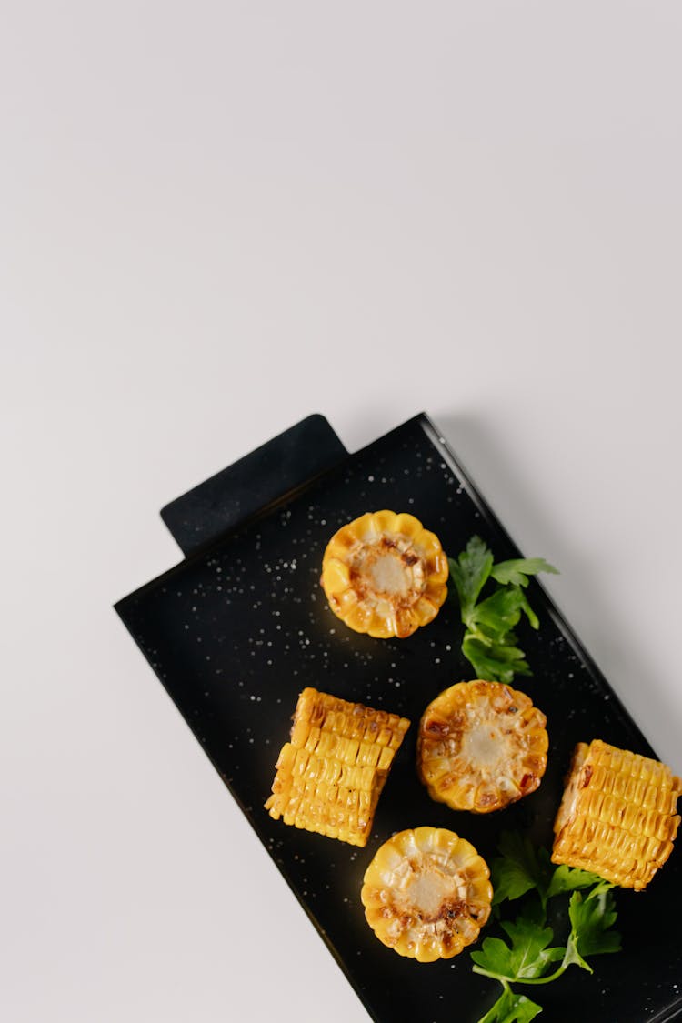 Overhead Shot Of Fried Corn On A Black Serving Tray