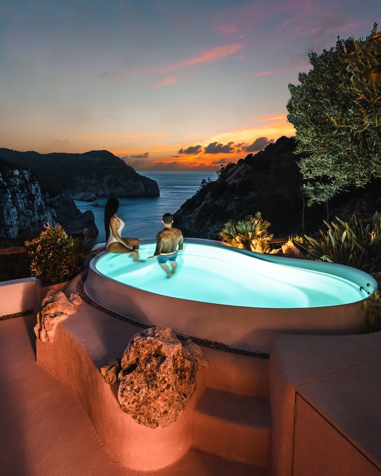 A Couple In Swimming Pool During Sunset