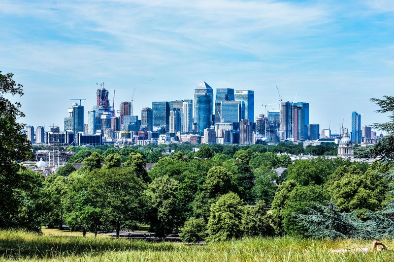 London skyline with Canary Wharf towers seen across greenery