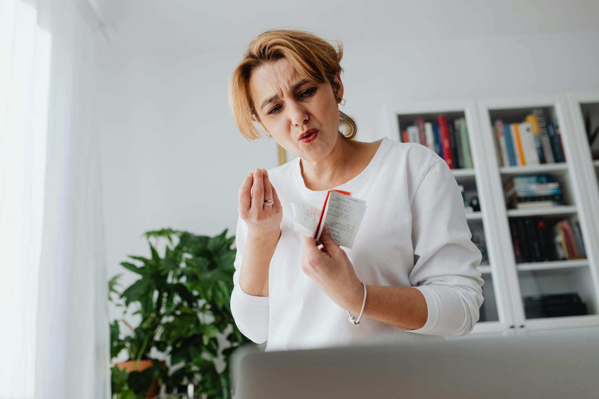 Surprised and Upset Woman Holding a Bunch of Receipts