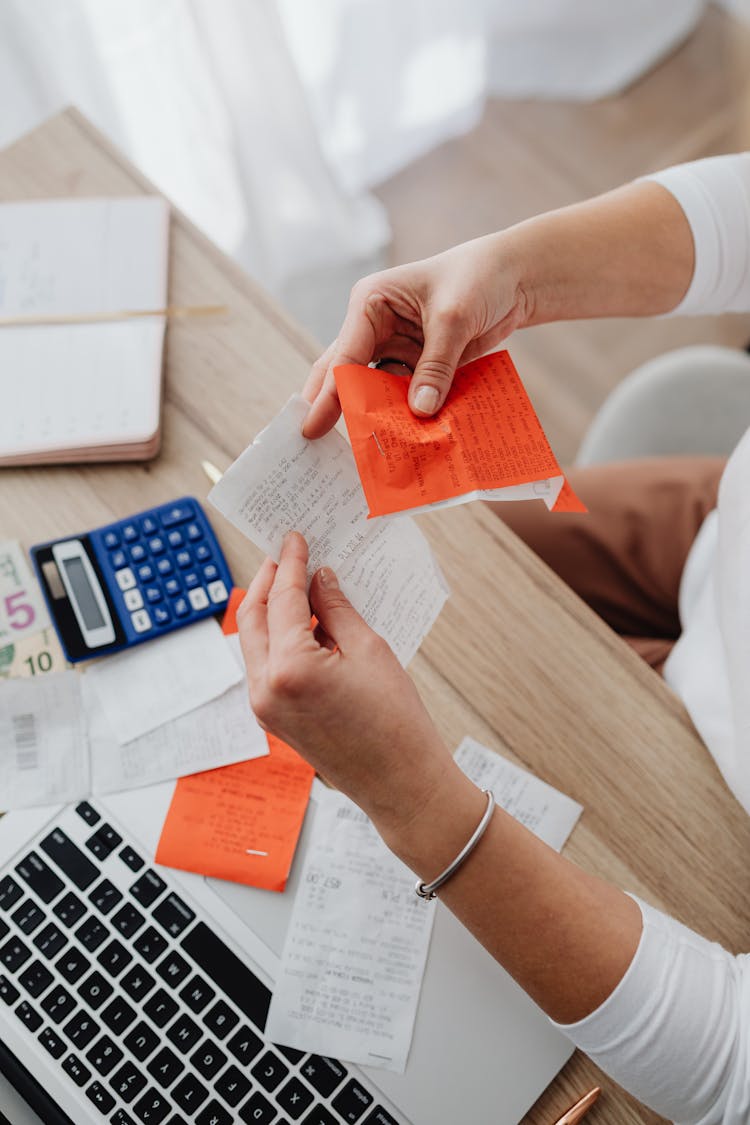 Hands Holding Receipt And Notes