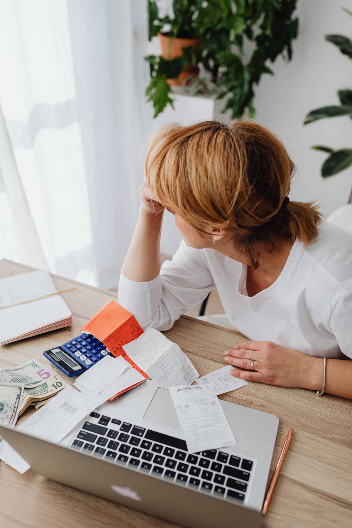 Person calmly reviewing financial plan and credit options on a laptop