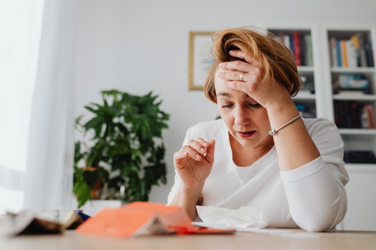 Woman With Hand On Forehead