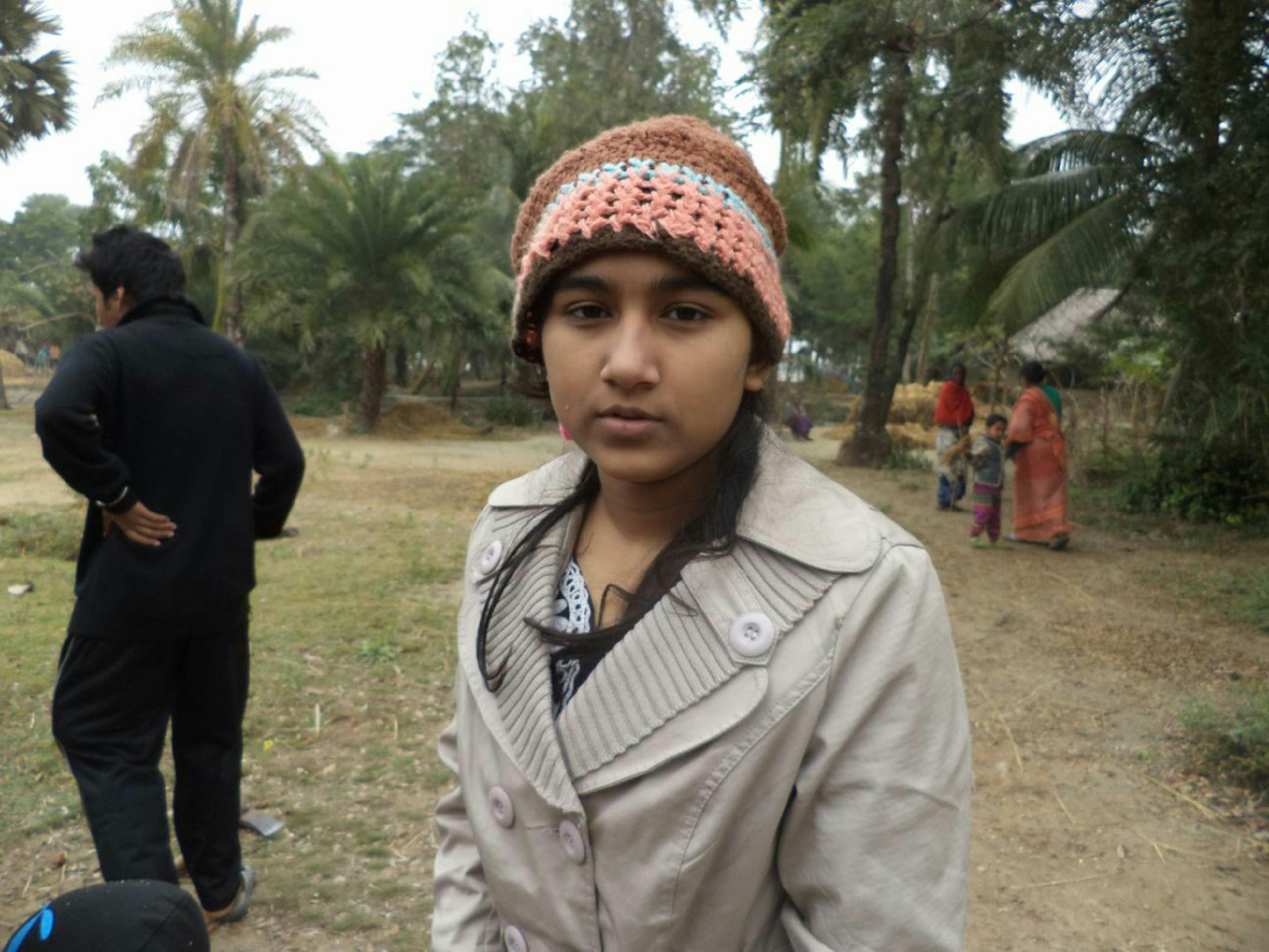 Doctor pointing at a chart showing disease curves on a screen