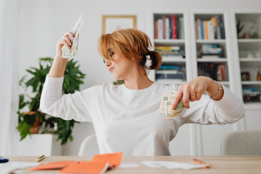 Woman in living room joyfully counting cash, expressing financial success and happiness.