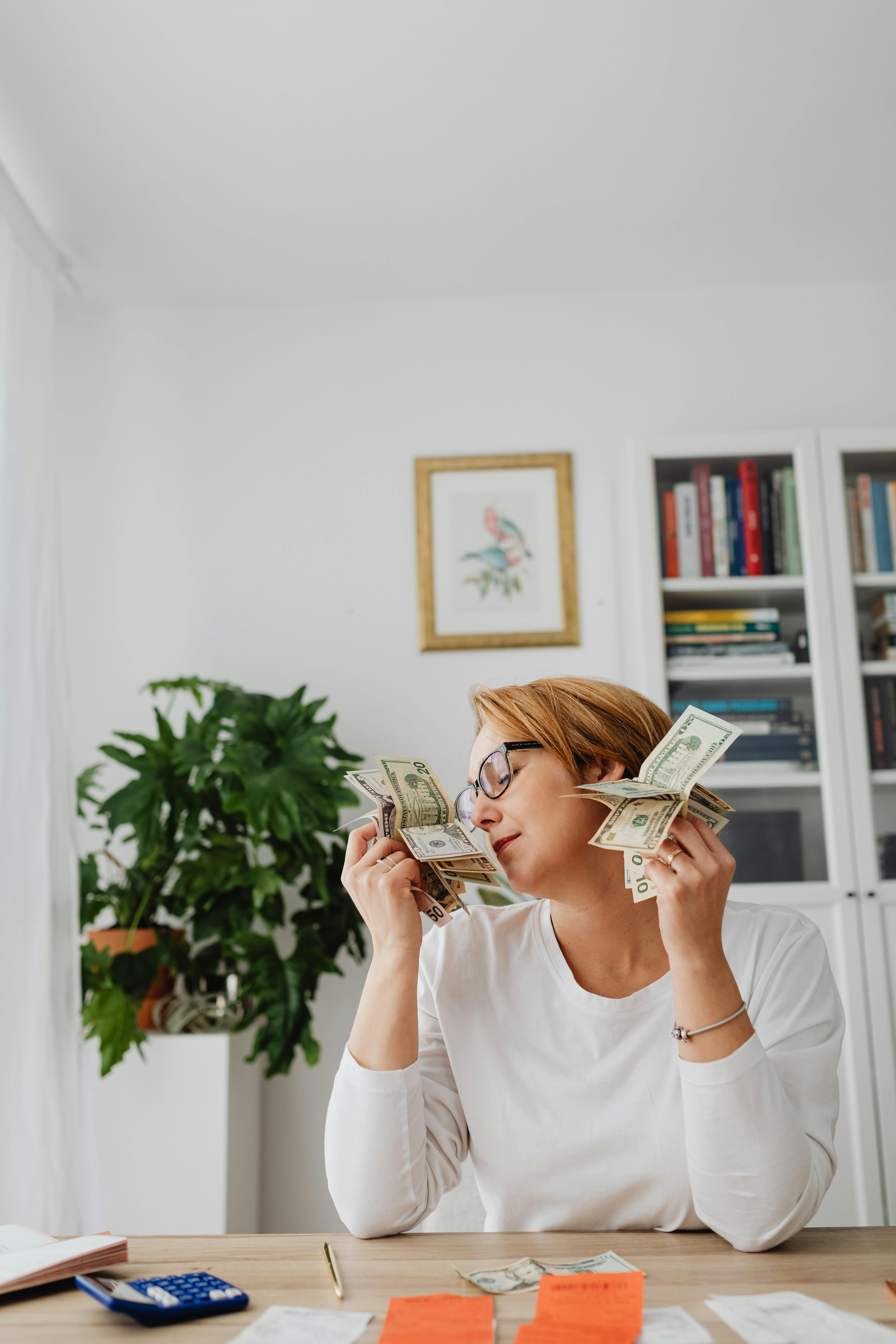 woman holding the money near her face