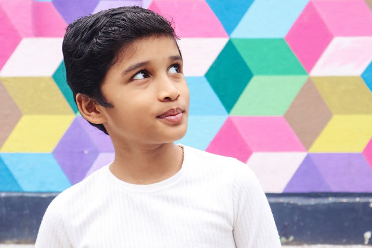 Happy Indian Boy Against Colorful Wall