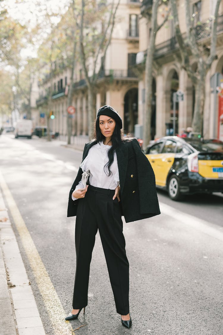 A Woman In Black Blazer Posing On The Road