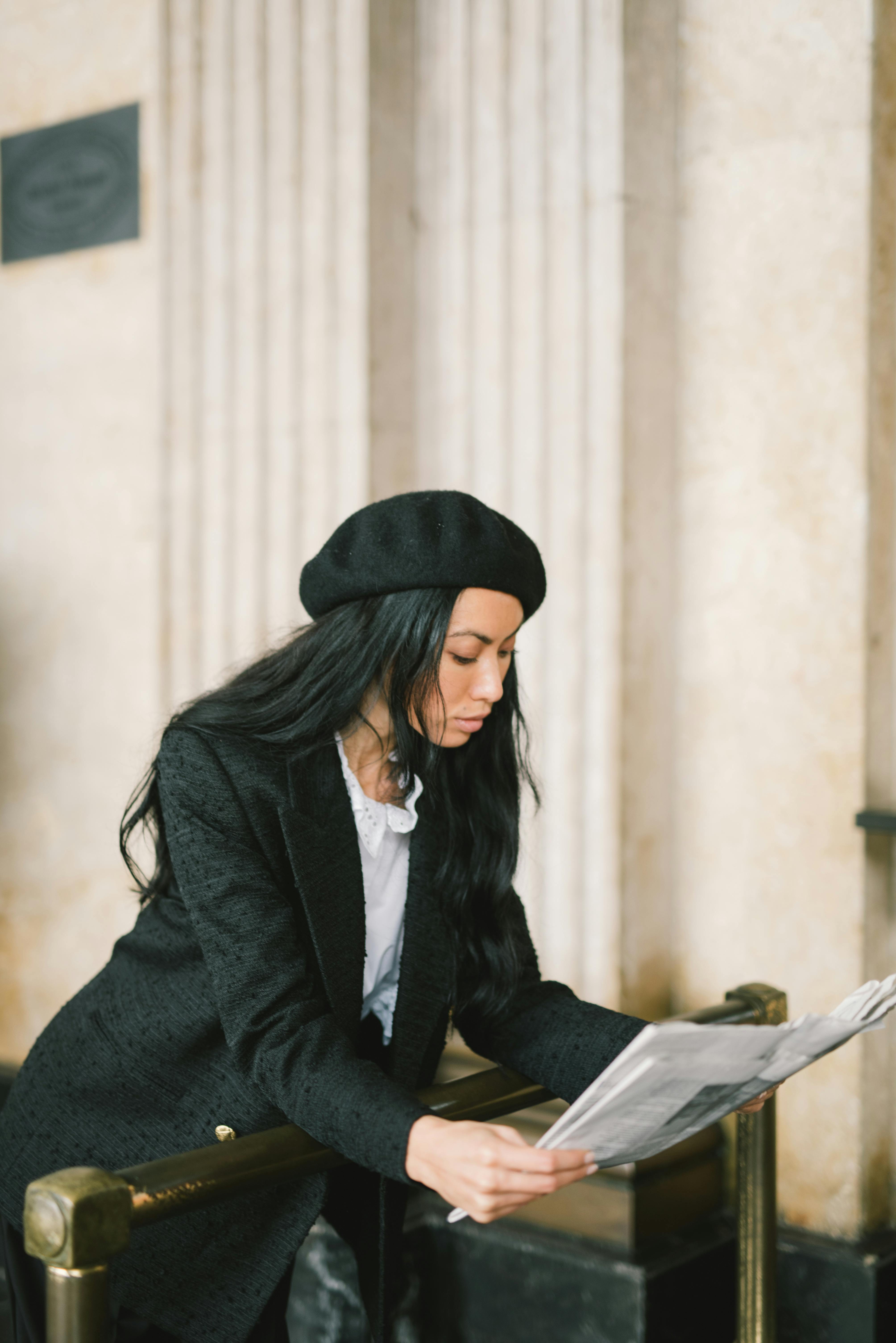 Woman in Black Coat and Black Beret Hat Holding Newspaper · Free