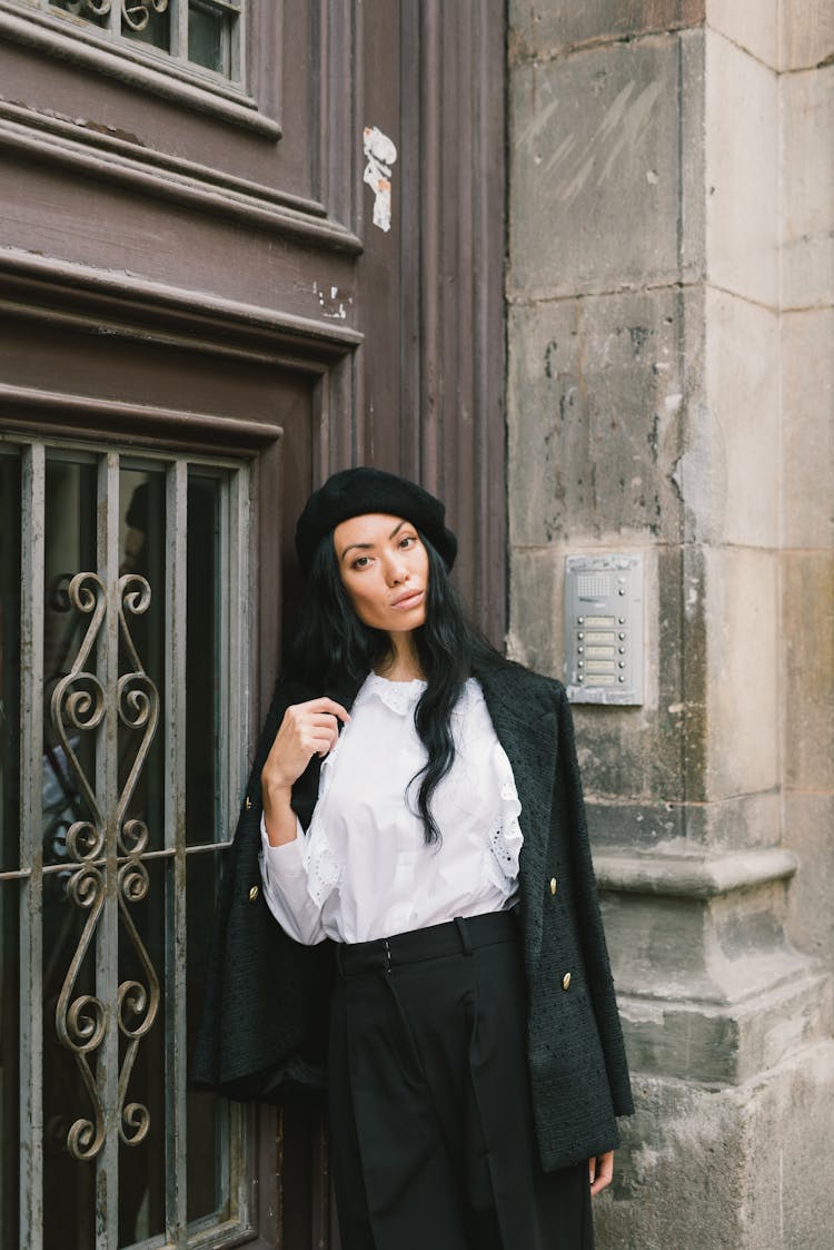 A Woman In White Long Sleeves Leaning On The Door