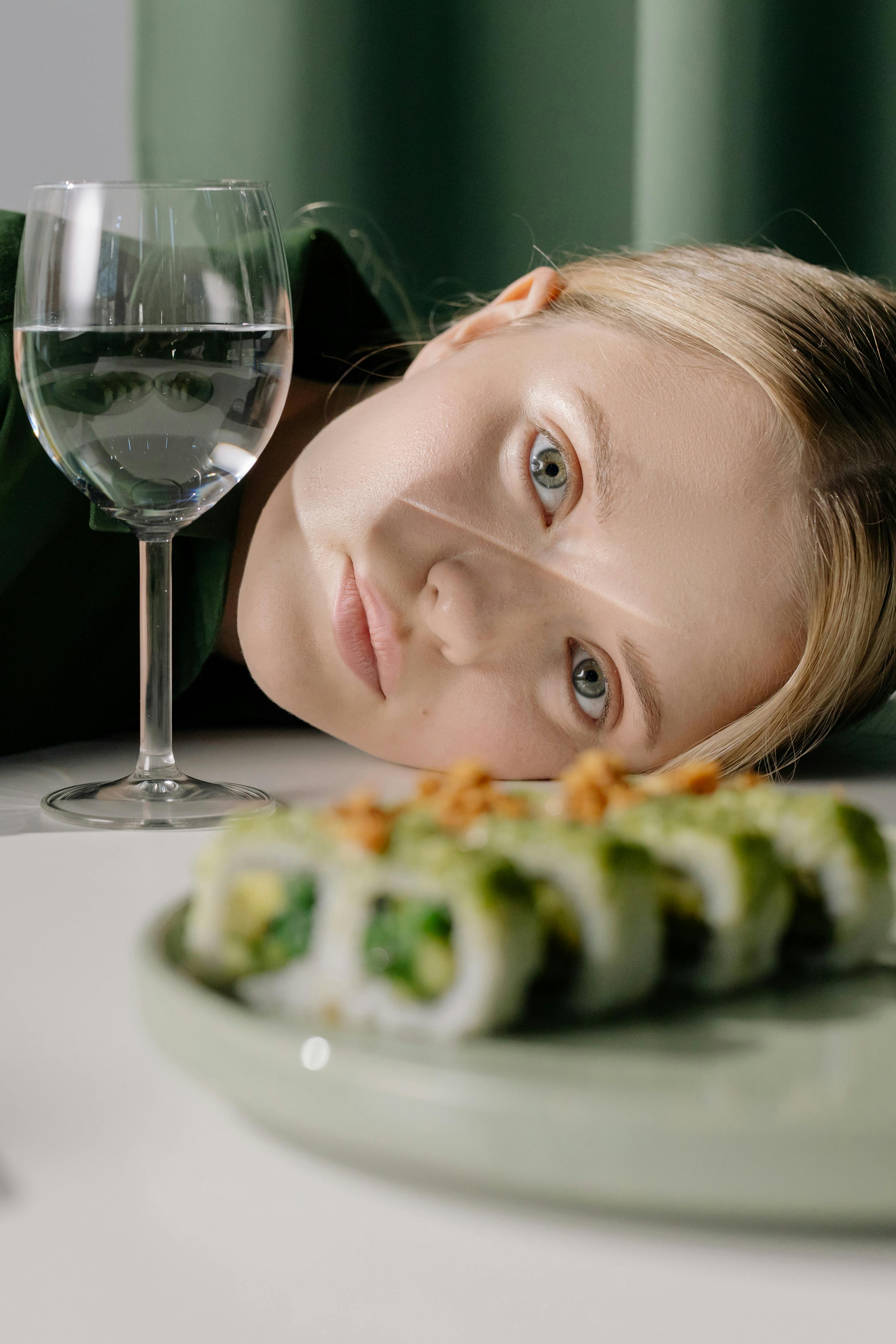 girl eating pizza on white ceramic plate