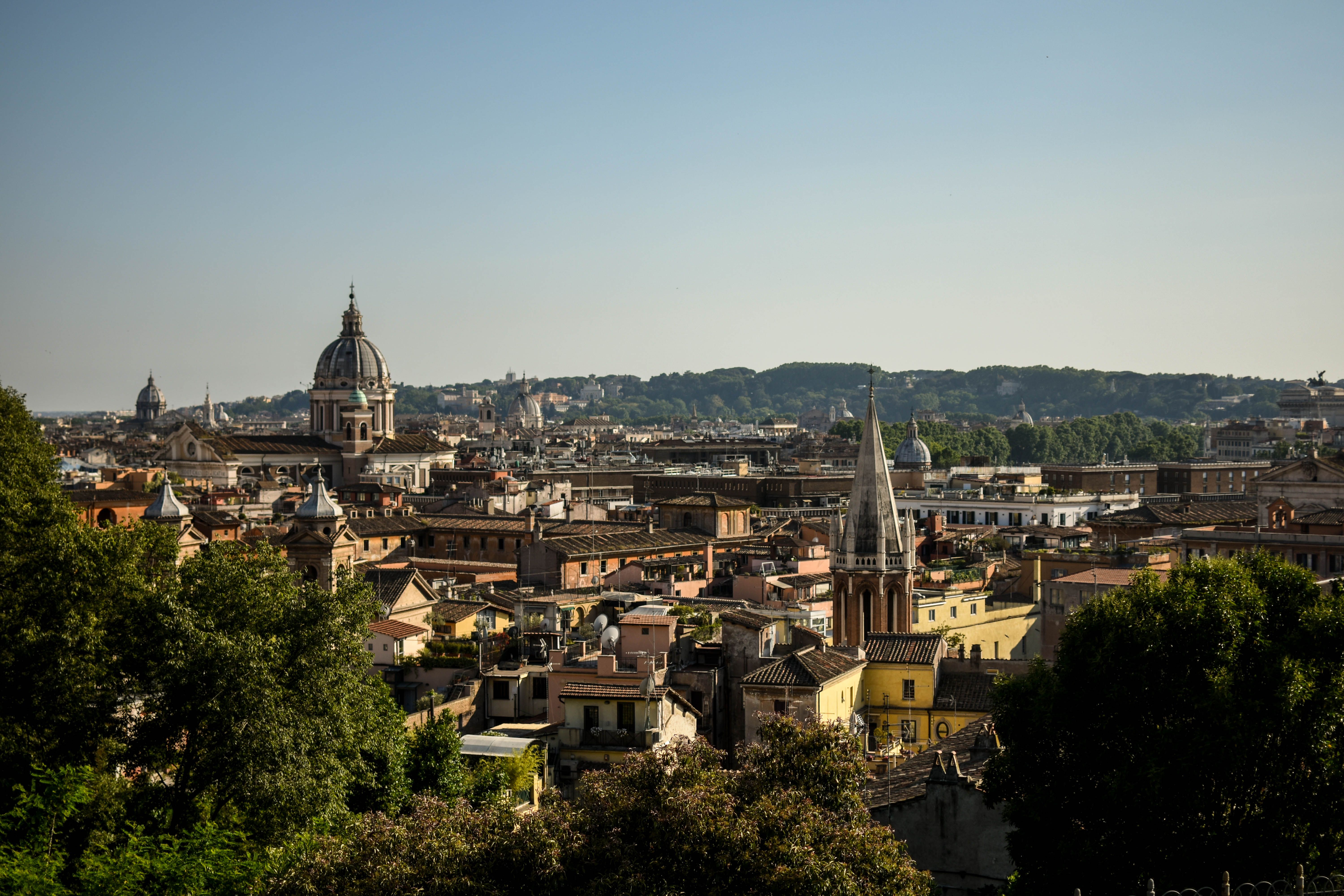 Stunning aerial view of Rome capturing iconic landmarks and historic architecture under a clear sky.