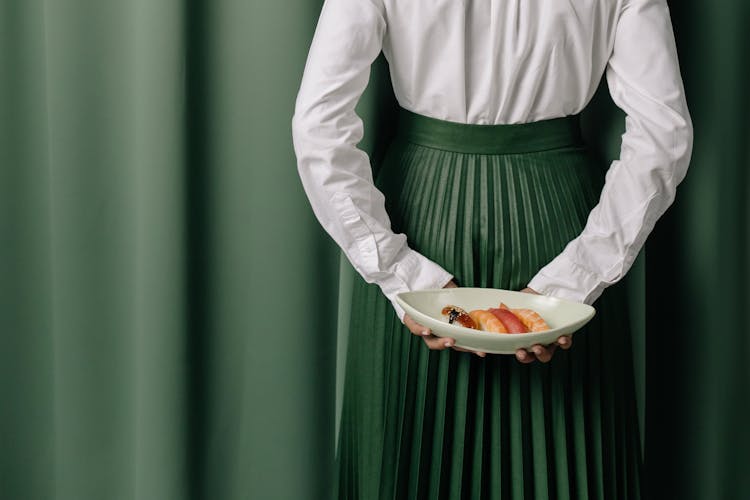 Person Holding A Delicious Dish From Behind