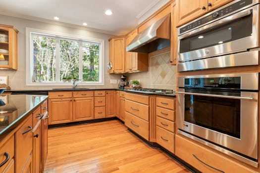 Bright, modern kitchen featuring wooden cabinets and stainless steel appliances.