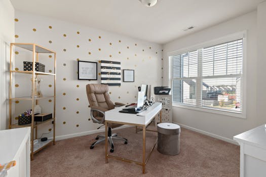 Stylish home office with gold polka dot wallpaper and white desk, showcasing modern decor.