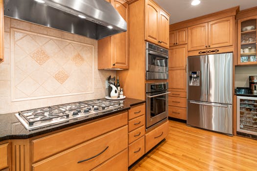 A cozy kitchen interior with wooden cabinets and stainless steel appliances.