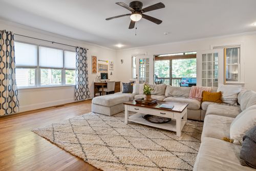 Free A cozy living room with modern decor, large windows, and ample natural light. Stock Photo
