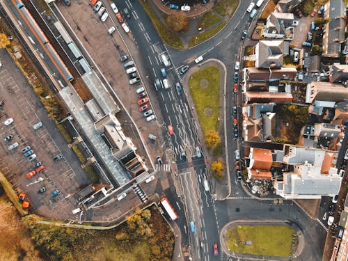 Cars driving on road in suburb area on sunny day