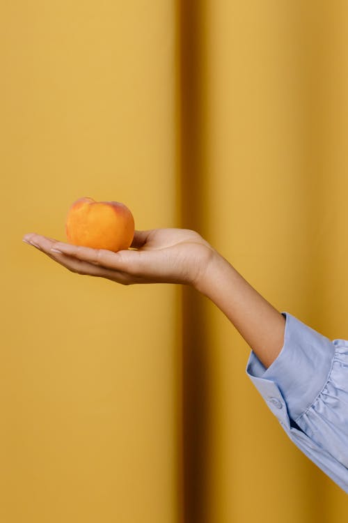 Hand Holding Peach
