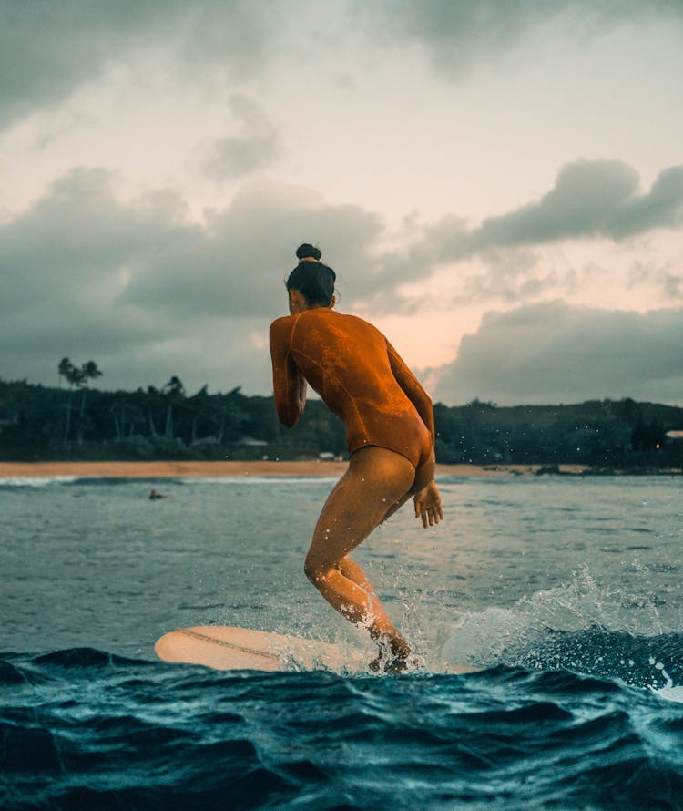 Surfer In Swimsuit Surfing On Board