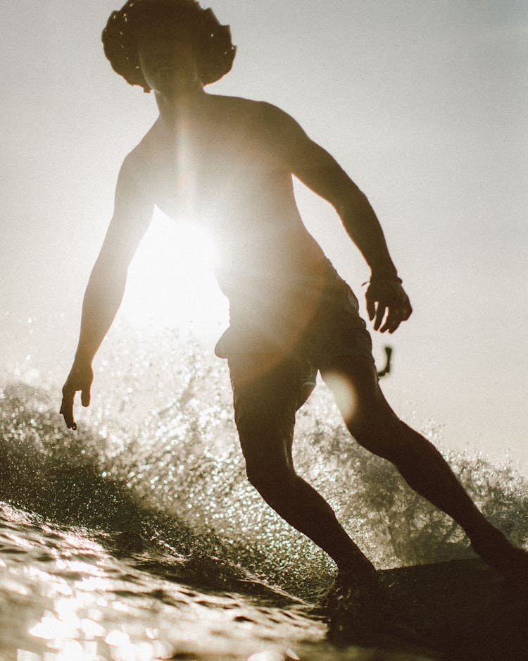 Unrecognizable Surfer Standing On Board