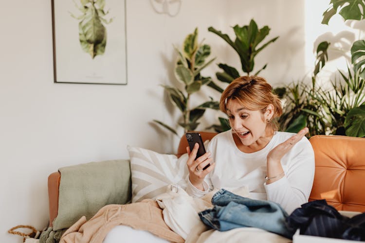 Excited Woman Looking At Her Phone 