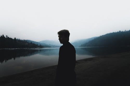 Person Standing Near Body of Water