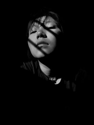 Grayscale portrait with hard shadow bands — photo by Wangchen Tsomu on Pexels