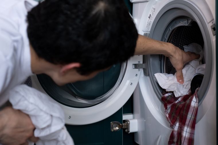 Technician inspecting a home appliance at night