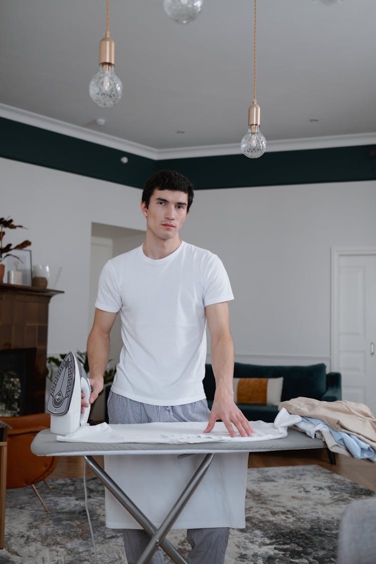 Man In White Shirt Ironing His Clothes