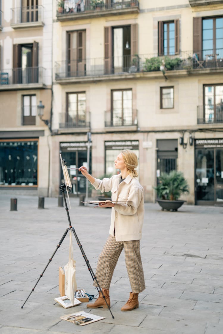 A Woman Painting On The Street